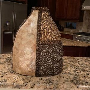 It’s a flower vase color is gold brown and off white